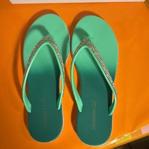 Bedazzled green flip-flops